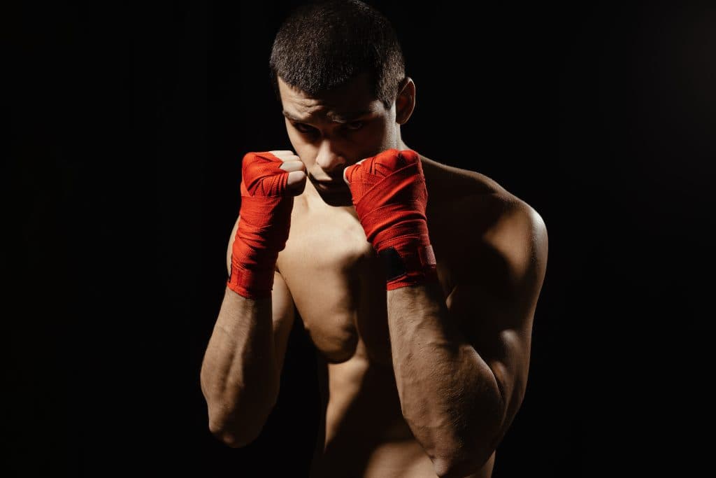 Boxer with hand wraps in a defensive stance